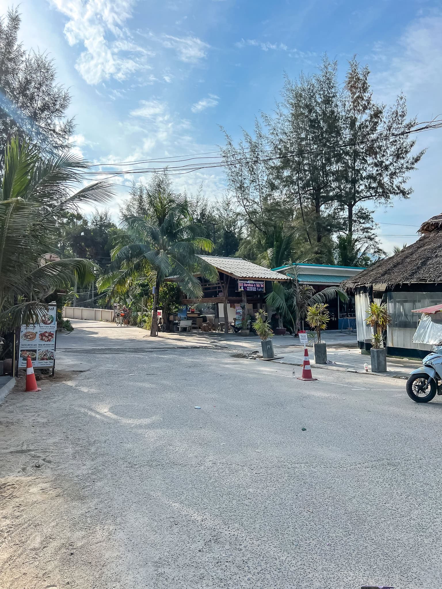 an access lane to the sand with scooters parked along it