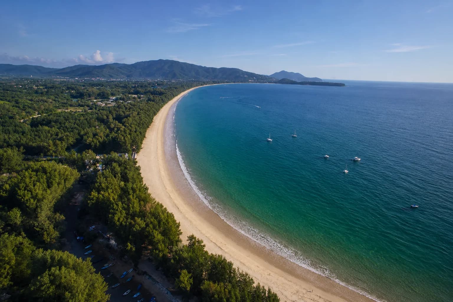 the whole bay from the air: the curve of sand from the Surin headland to Layan, the sea and the green behind