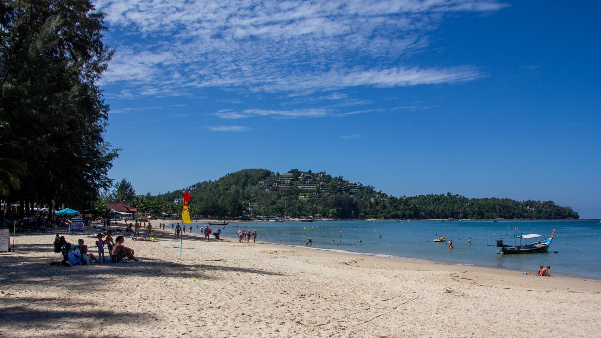 the southern stretch: families in calm water, the Surin hillside behind