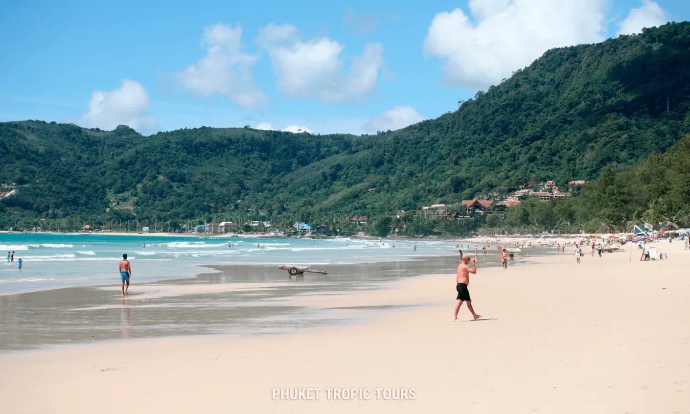 wide sand, the water and the green hills