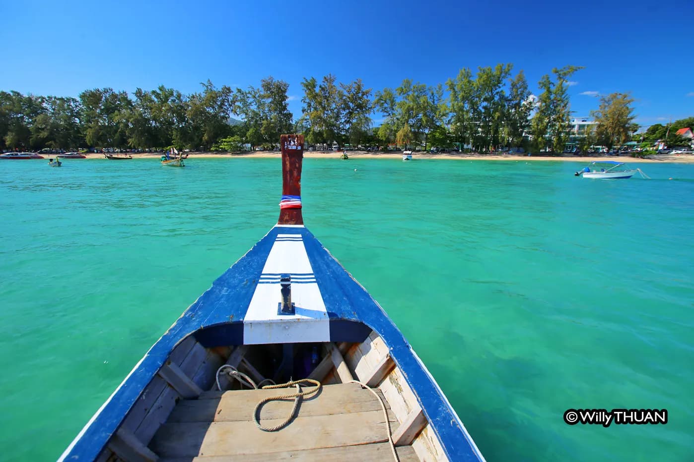 a longtail boat leaving for the islands