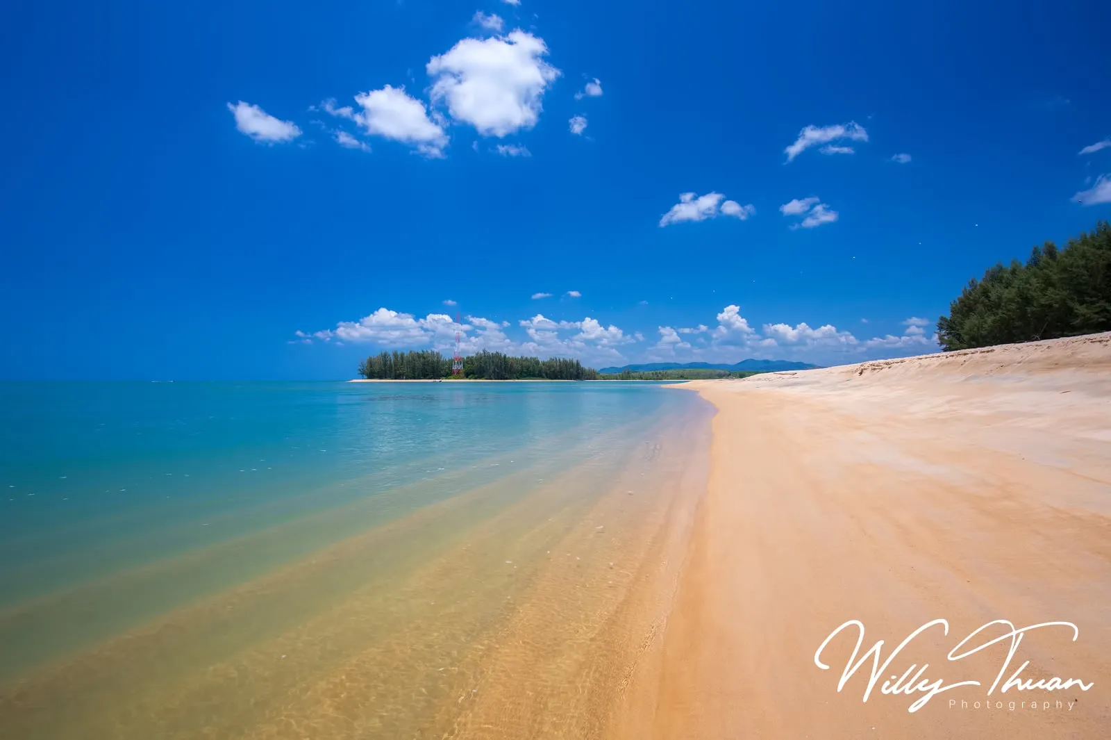 white sand, turquoise water and an island offshore