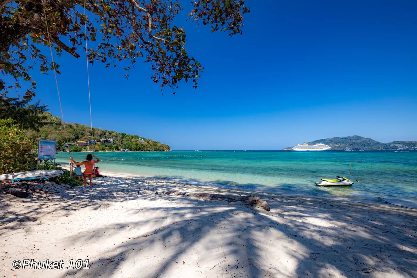 the sand and the calm water in the shade